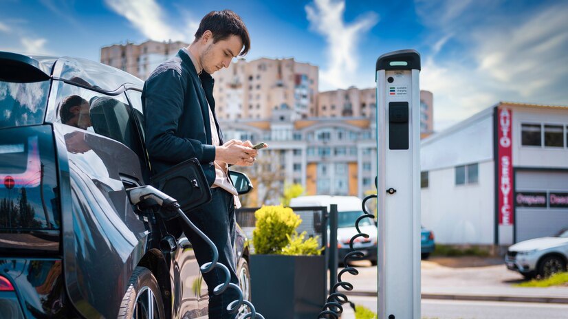 man-charging-his-electric-car-charge-station-using