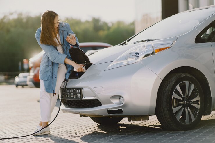 woman-charging-electro-car-electric-gas-station_11