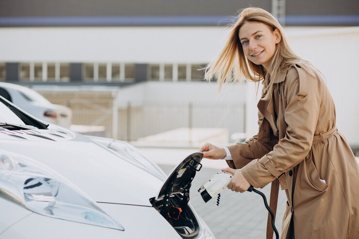 young-woman-charging-her-electric-car-with-chargin