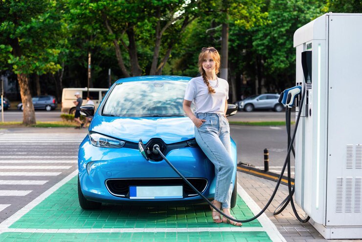 young-woman-with-electric-car-charging-station-chi